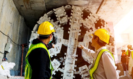 Image of two engineers with tunnel boring machine